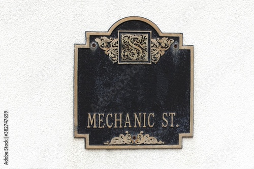 Mechanic Street  historic plaque on white building in The Strand in Galveston Island, Texas.