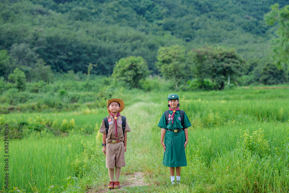 Asian boys and girls scouts students in Thailand Wearing a boy scout's uniform Going camping and hiking in the outdoor forest