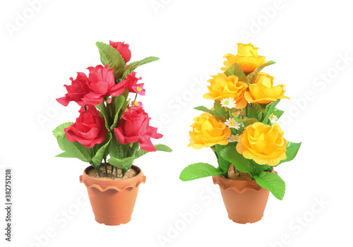 The artificial  flower red and yellow in the pot isolated on white background with clipping path