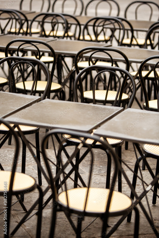 Tables and chairs set up outside a restaurant