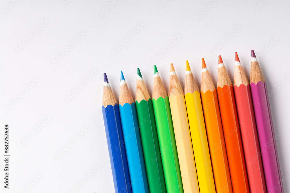 colored pencils in row on a white background colored pencils in row on a white background