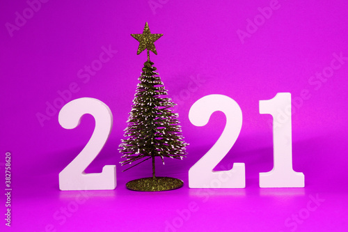 xmas celebration 2021 on number wooden with xmas tree or christmas tree on purple violet background - Happy new year 2021 - Countdown celebrate concept 