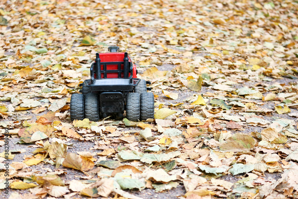 toy offroad car in the autumn leaves in the park toy offroad car in the autumn leaves in the park