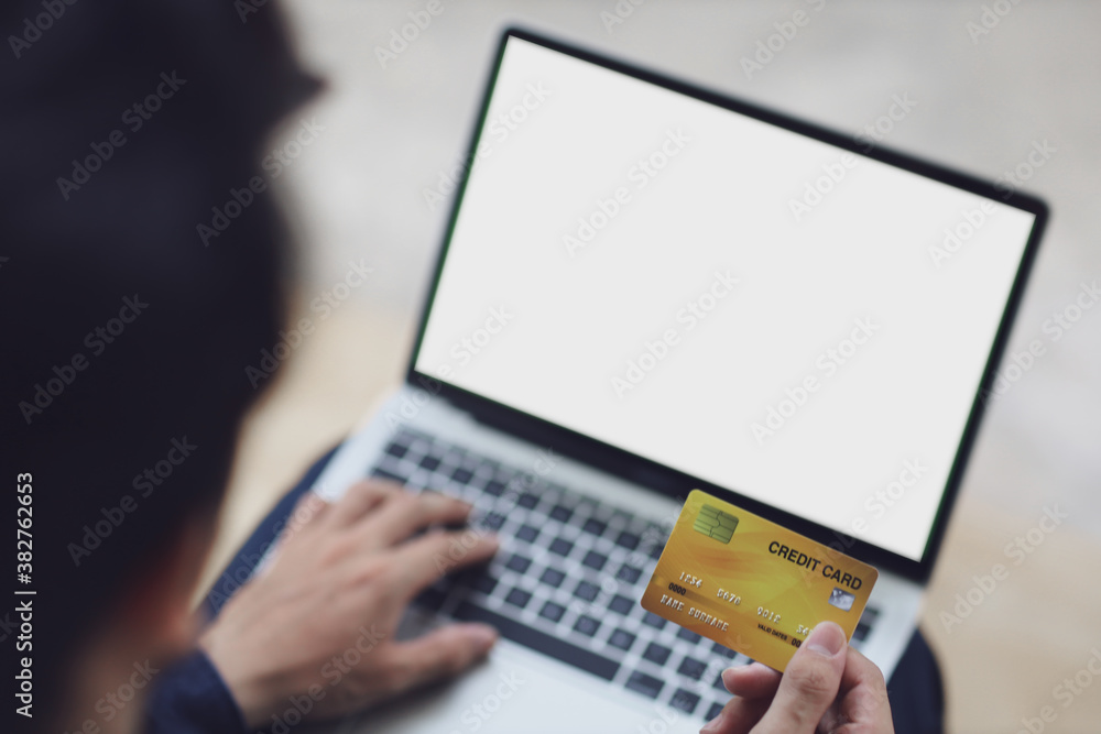 Man using blank laptop and credit card sending massages shopping online. Man using blank laptop and credit card sending massages shopping online.