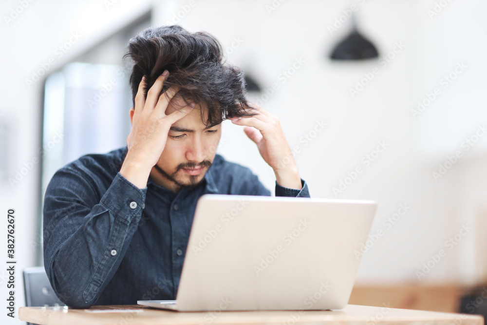 Young man asia tired man under stress in the office Young man asia tired man under stress in the office