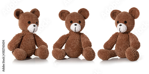 Knitted toy. Brown bear on white background. Three position. Full depth of field. With clipping path.