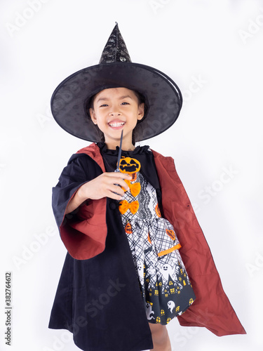 Asian children girl in witch dress costume Casting magic for Halloween decoration in white background