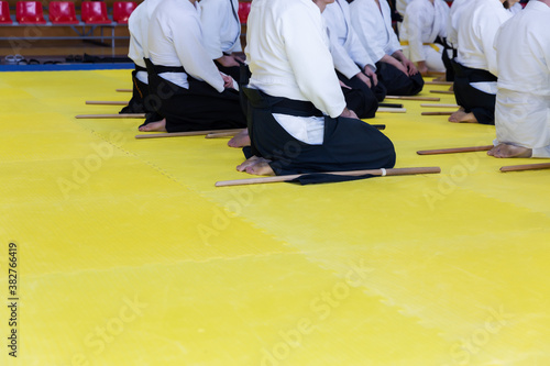 People in kimono on martial arts weapon training seminar