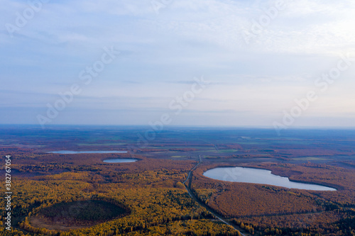 Aerial photo of some lakes surrounded by colorful forest in autumn.