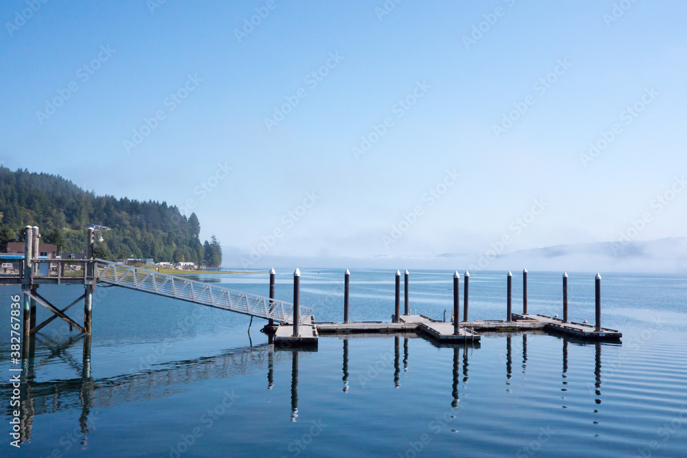 Pier on the water with fog