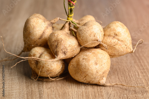 Fresh jicama or yam on wooden table