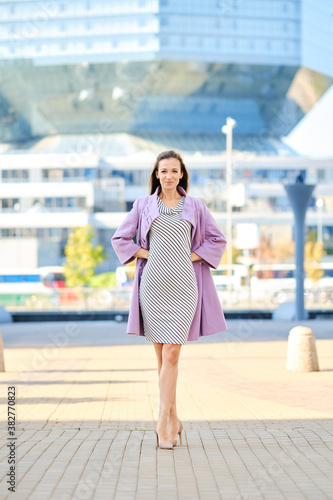Trendy woman in lilac coat and dress with stripes Free Download Trendy woman in lilac coat and dress with stripes - GFXLoad