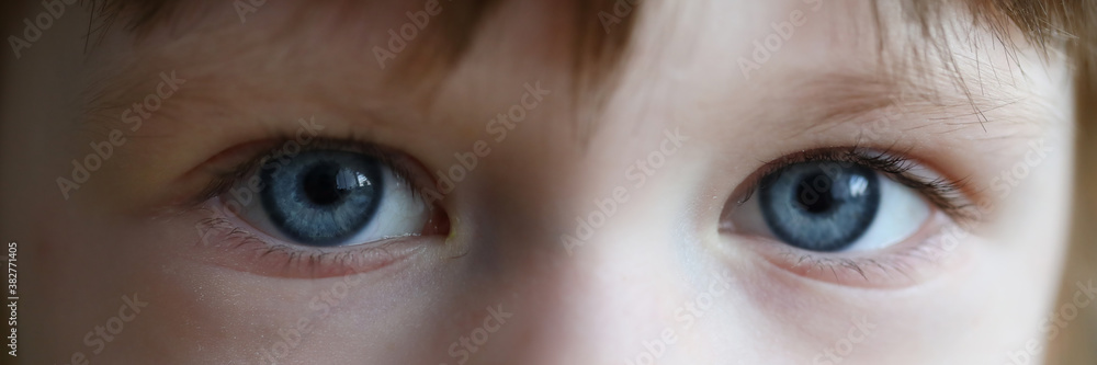 Close-up of little girl eyes. Beautiful blue eyes of child. Macro shot of kid face. Windows of soul. Blonde attractive toddler. Childhood and modeling concept Close-up of little girl eyes. Beautiful blue eyes of child. Macro shot of kid face. Windows of soul. Blonde attractive toddler. Childhood and modeling concept