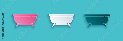 Paper cut Bathtub icon isolated on blue background. Paper art style. Vector.
