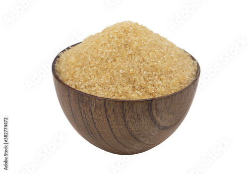 Pure brown sugar in natural wooden bowl isolated on white background