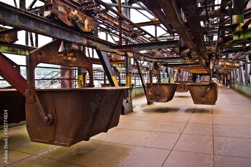 UNESCO World Heritage site: Volklingen Ironworks, Germany. Old rasty mine wagons in a transportation room.
