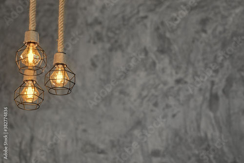 Decorative antique edison style light bulbs against Bare cement wall background