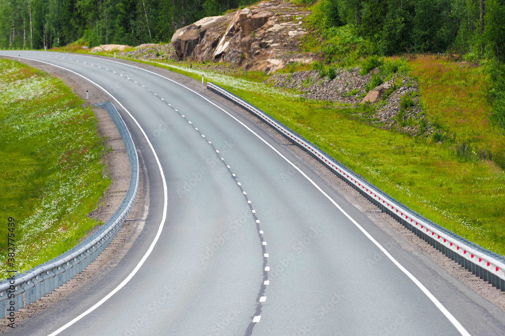 Mountain road going into the distance, road turn, summer wooded landscape Mountain road going into the distance, road turn, summer wooded landscape