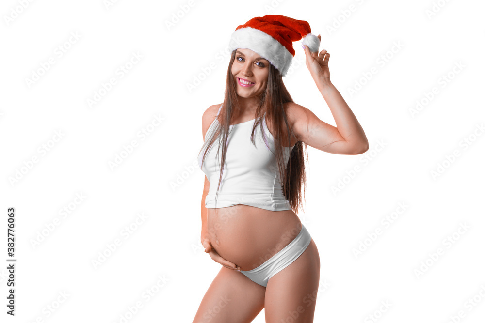 Pregnant woman in lingerie and Santa hat over white background. Pregnant woman in lingerie and Santa hat over white background.