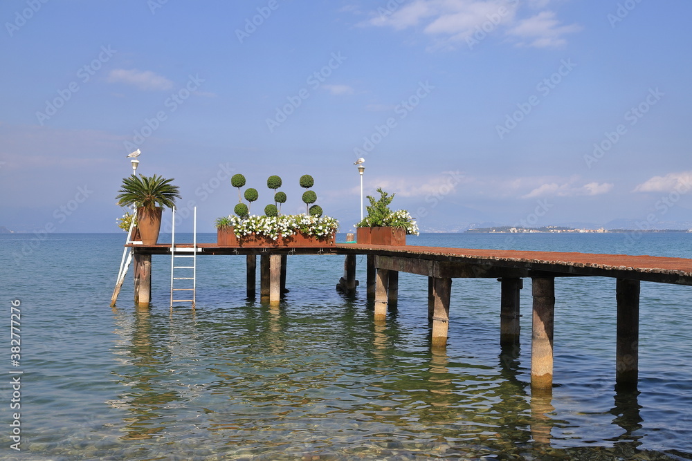 Lake Garda Pier.  The view along a wooden pier on the banks of Lake Garda in North East Italy.