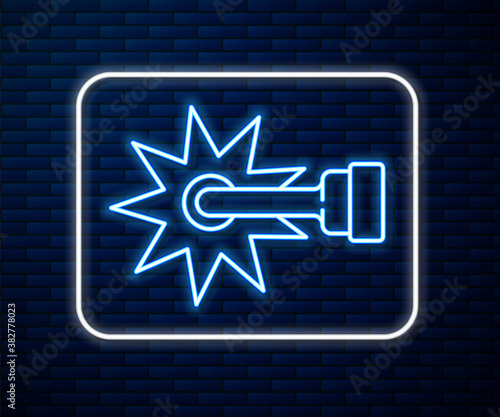 Glowing neon line Cowboy horse riding spur for boot icon isolated on brick wall background. Vector.