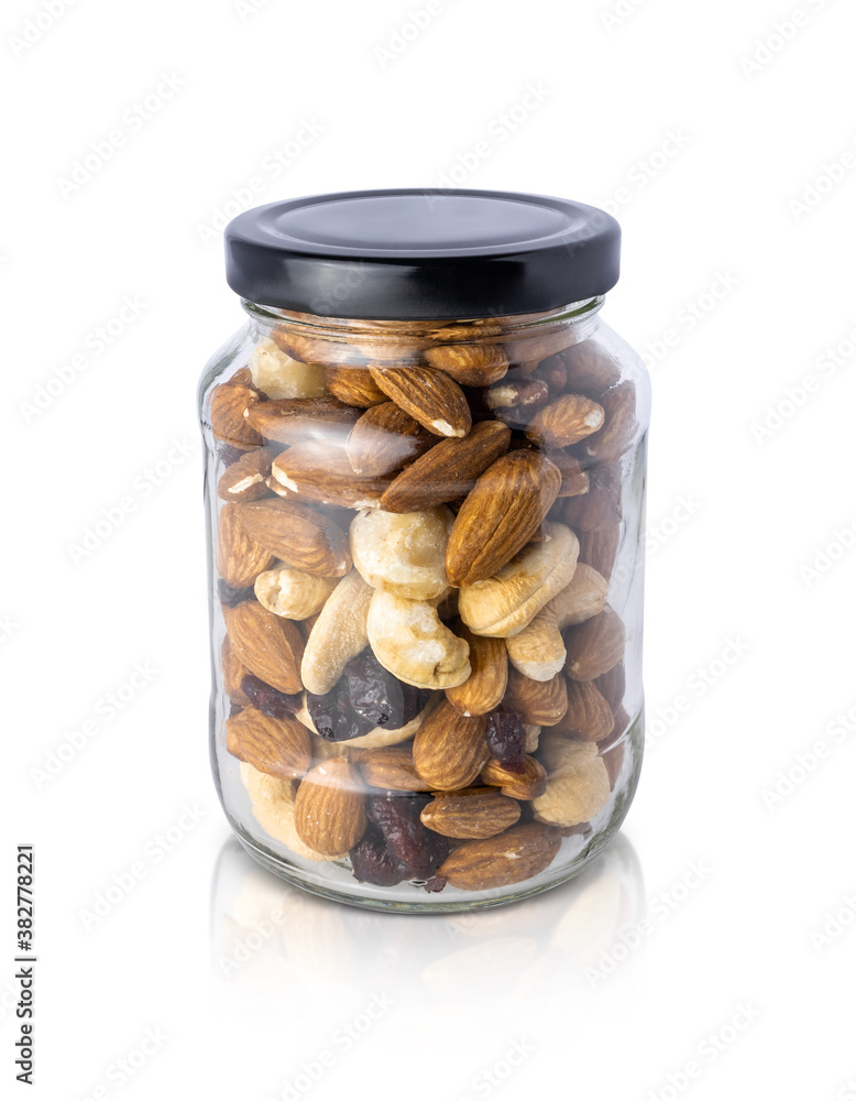 Clear glass bottle with mixed nuts healthy organic food isolated on white background Clear glass bottle with mixed nuts healthy organic food isolated on white background