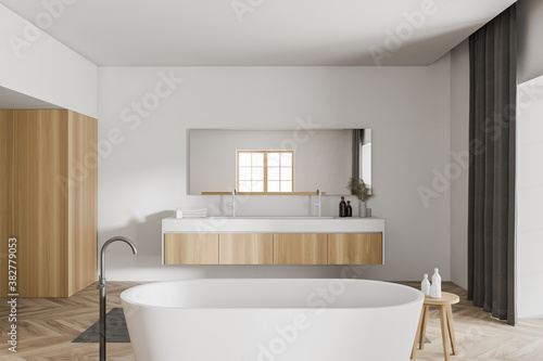 Modern white and wooden bathroom interior with tub and sink