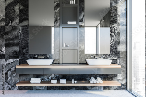 Double sink in modern black marble bathroom