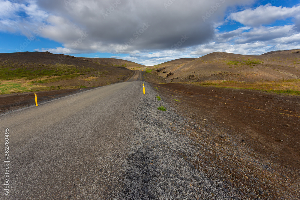 Fototapeta premium Typical Icelandic landscape with asphalt road, Iceland.