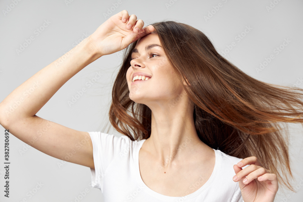 side view of woman with long hair smiling and holding hand side view of woman with long hair smiling and holding hand