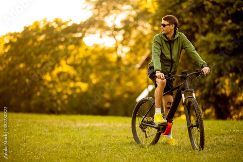 Young man riding ebike in the park photo