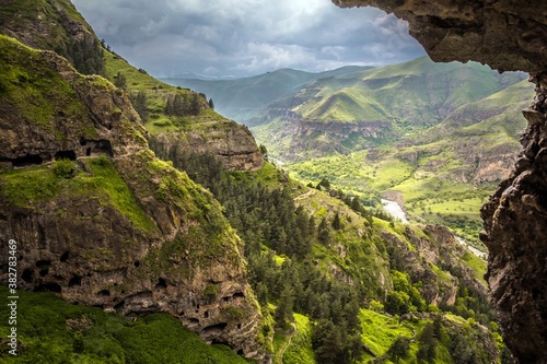 Gorgeous view from Vanis Kvabebi on a green valley in the mountains and a narrow river against cloudy sky in Samtskhe-Javakheti, Georgia. © Алексей Мараховец