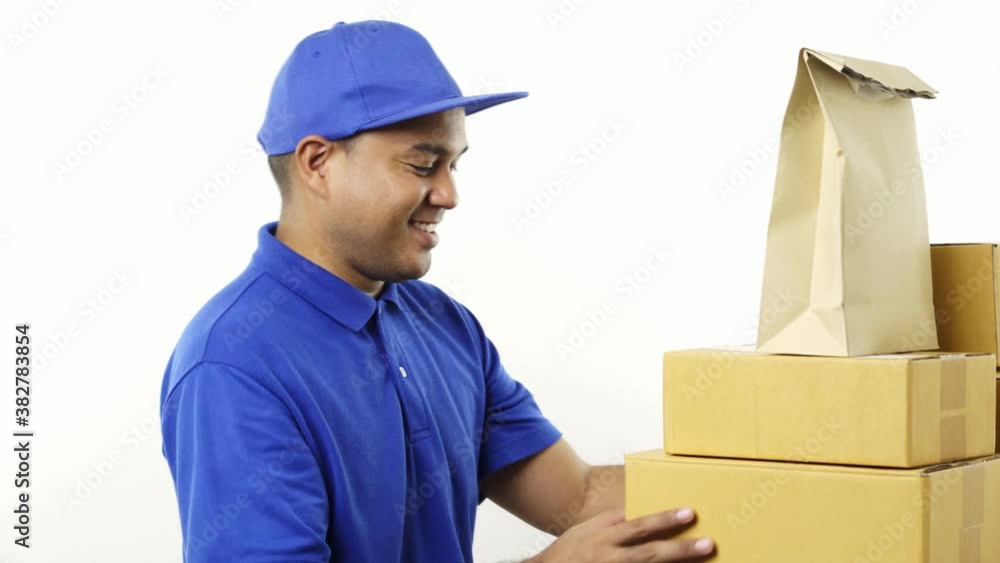 Young asian delivery man in blue uniform arrange products parcel stock for sending to customer. 4k Resolution. Young asian delivery man in blue uniform arrange products parcel stock for sending to customer. 4k Resolution.