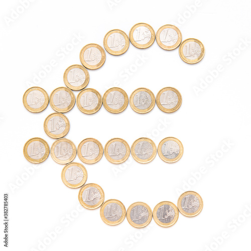 symbol of euro made of coins, the sign is on white background 