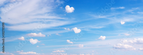 Photography Clouds with heart shape form flying on blue panoramic sky