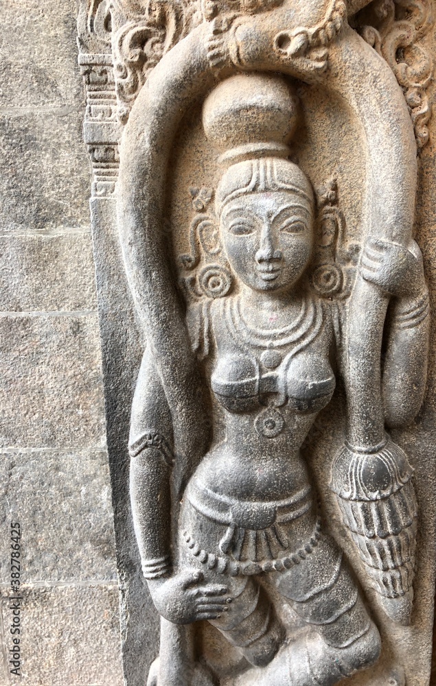 Statue of hindu goddess carved in the walls of ancient temple. Bas relief sculptures carved in the walls of Kapaleeshwarar temple in Tamil nadu.