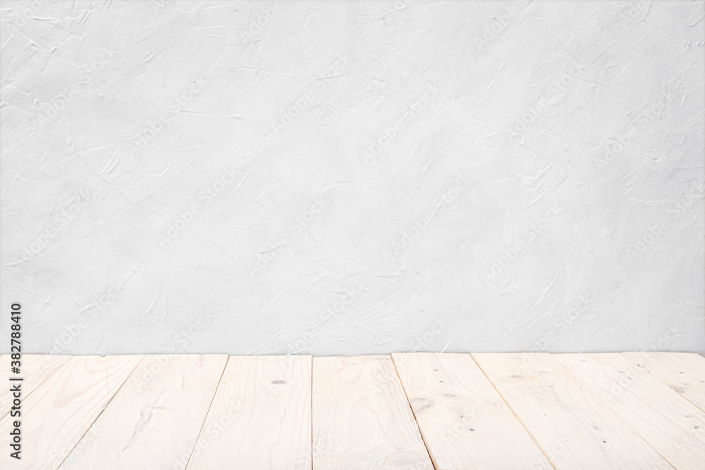 Fototapeta premium Empty wooden deck table over white textured wall background