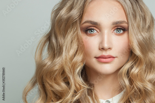 Beautiful young fashion model woman with long healthy curly hairstyle