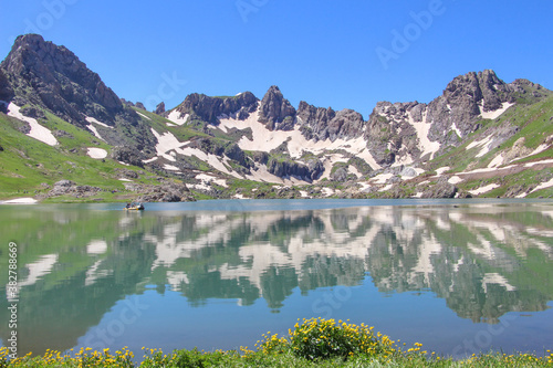 a glacial lake in mountains, winter season, cold weather and blue sky, snowy mountains 