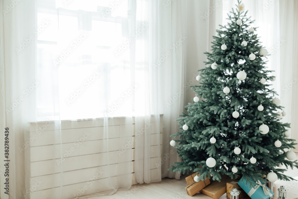 Christmas tree Christmas decoration interior of the white room with postcard gifts Christmas tree Christmas decoration interior of the white room with postcard gifts