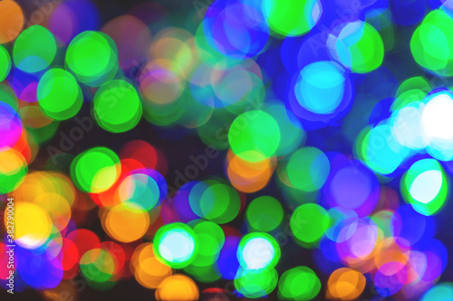 Colourful festive multi-colored circles . Defocused abstract multicolored bokeh lights background. Rainbow bokeh effect. Holiday postcard.