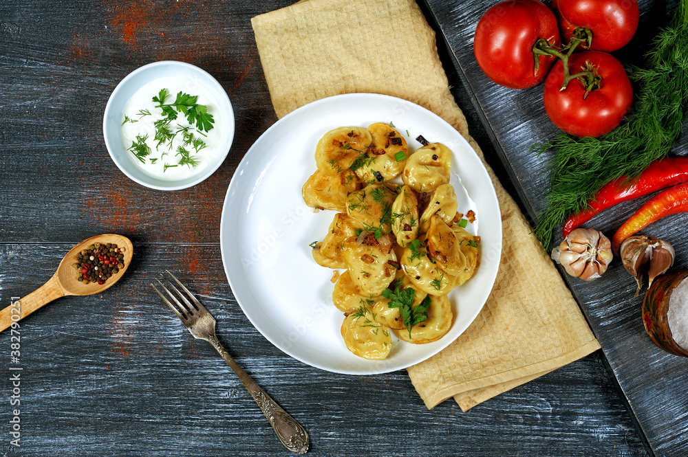 Dumplings with potatoes and onions on a plate . The view from the top