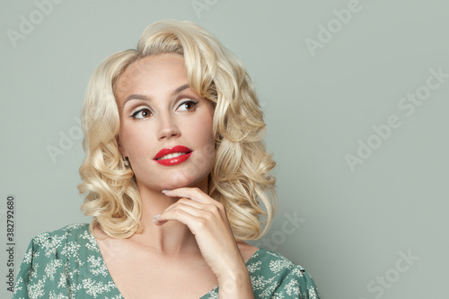 Blonde woman model with curly hairstyle and makeup