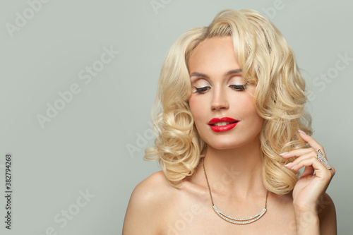 Cute young woman with blonde curly hair