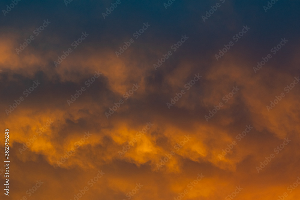 a close up of golden clouds on the horizon during a sunset over the Mediterranean sea