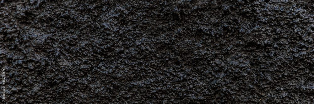 Fototapeta premium Black panoramic background. Grain black painted wall texture background