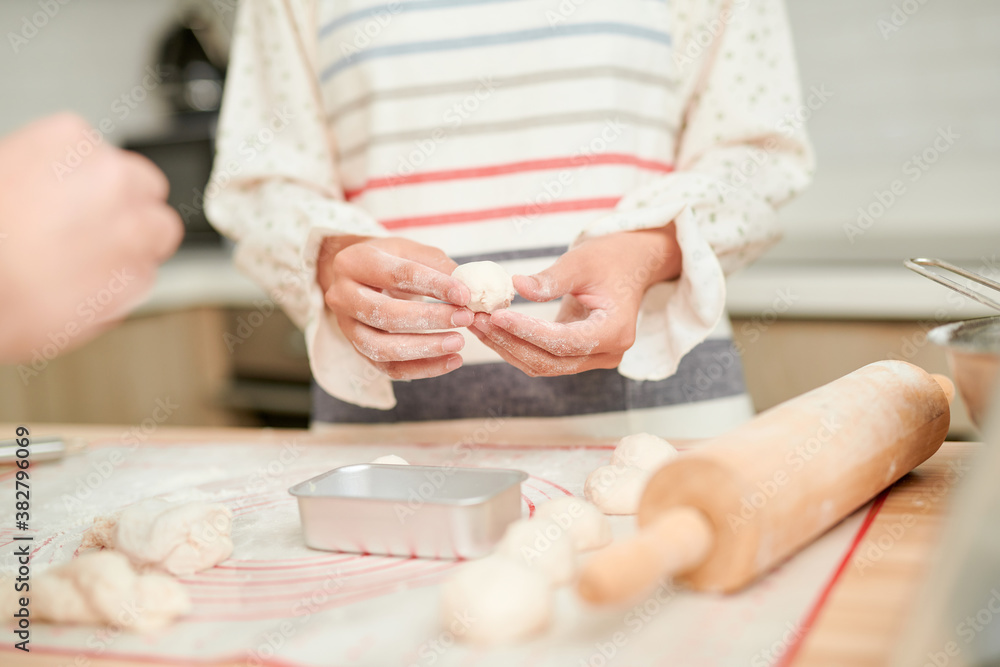 Making dough by female hands on wooden table background Making dough by female hands on wooden table background