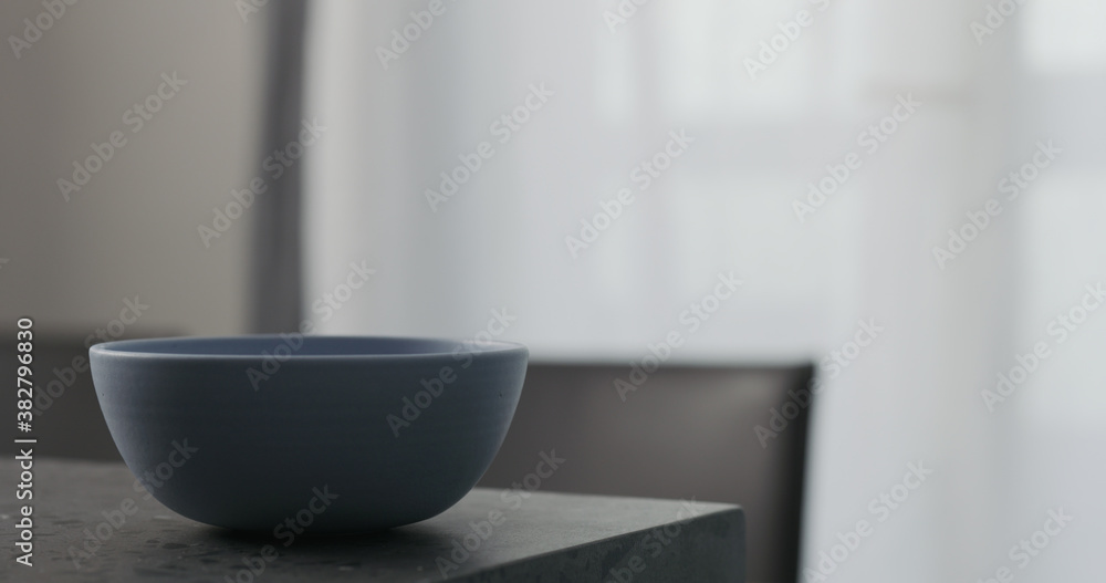 Empty blue bowl on concrete countertop with copy space Empty blue bowl on concrete countertop with copy space
