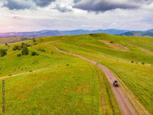 ATV rider rides through forest off-road in summer © Parilov