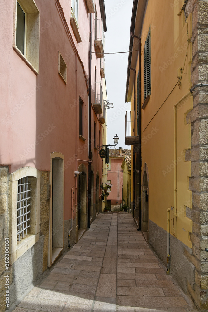 Obraz premium A narrow street among the old houses of Mirabello Sannitico, a medieval village in the province of Campobasso, Italy